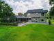 Beautiful two-story home featuring a screened-in pool and lush green lawn at 1256 Center St, Lake Wales, FL 33859