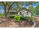Charming exterior view of a home surrounded by lush greenery and landscaping at 1256 Center St, Lake Wales, FL 33859