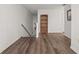 Bright hallway featuring stylish wood floors, a bookcase, and natural light at 1256 Center St, Lake Wales, FL 33859