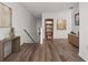 Bright hallway featuring stylish wood floors, a console table, and a bookcase at 1256 Center St, Lake Wales, FL 33859