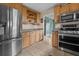 Well-equipped kitchen with stainless steel appliances, ample cabinet space, and a view to the dining area, perfect for cooking at 1256 Center St, Lake Wales, FL 33859