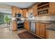 Modern kitchen featuring stainless steel appliances, granite countertops, and wooden cabinets providing a stylish and functional space at 1256 Center St, Lake Wales, FL 33859