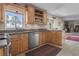 Bright kitchen area with stainless steel appliances, granite countertops, and a large window for natural light and outdoor views at 1256 Center St, Lake Wales, FL 33859