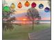 Picturesque view of a serene landscape with a colorful sunset through decorative glass orbs at 1256 Center St, Lake Wales, FL 33859