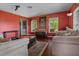 Cozy living room area with hardwood floors, comfortable seating, and large windows for natural light, creating a relaxed atmosphere at 1256 Center St, Lake Wales, FL 33859