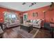 Inviting living room featuring cozy seating, hardwood floors, and natural light creating a welcoming atmosphere at 1256 Center St, Lake Wales, FL 33859