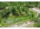 Scenic aerial view of a tranquil pond surrounded by lush greenery and natural landscape at 1273 Scrub Jay Trl, Frostproof, FL 33843