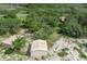 Aerial view showcasing the property's outbuildings and lush surroundings at 1273 Scrub Jay Trl, Frostproof, FL 33843