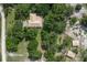 Aerial view of home nestled among mature trees, showcasing privacy and lush surroundings at 1273 Scrub Jay Trl, Frostproof, FL 33843
