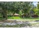 Picturesque backyard featuring mature trees, a gazebo, and a shed, perfect for outdoor living at 1273 Scrub Jay Trl, Frostproof, FL 33843