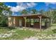 A horse barn with three stalls, an attached building, and sturdy wooden construction, providing shelter and functionality at 1273 Scrub Jay Trl, Frostproof, FL 33843