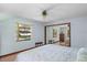 Light bedroom with large windows, providing ample natural light and closet at 1273 Scrub Jay Trl, Frostproof, FL 33843