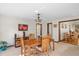 Bright dining room with classic chandelier, wooden table, and stylish chairs, perfect for Gathering meals and gatherings at 1273 Scrub Jay Trl, Frostproof, FL 33843