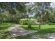 A tree-lined driveway leads to a secluded home surrounded by lush greenery, offering privacy and natural beauty at 1273 Scrub Jay Trl, Frostproof, FL 33843