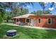 Home exterior showcases a patio with seating and a grill, perfect for outdoor gatherings and relaxation at 1273 Scrub Jay Trl, Frostproof, FL 33843