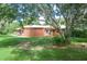 Home exterior features a charming backyard area with a patio, perfect for outdoor dining and entertaining at 1273 Scrub Jay Trl, Frostproof, FL 33843