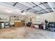 Large three-car garage with laundry area, workbench, and ample space for storage and projects at 1273 Scrub Jay Trl, Frostproof, FL 33843