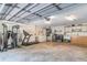 A spacious three-car garage featuring a workbench, gym equipment, and laundry hookups at 1273 Scrub Jay Trl, Frostproof, FL 33843