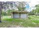 Two car garage with white doors, offering secure parking and storage space in a serene, grassy setting at 1273 Scrub Jay Trl, Frostproof, FL 33843