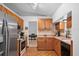 Efficient kitchen with wood cabinets and stainless steel appliances, perfectly designed for culinary adventures and Gathering meals at 1273 Scrub Jay Trl, Frostproof, FL 33843