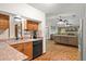 Functional kitchen with wood cabinets, open view to great room with stone fireplace, ideal for easy entertaining at 1273 Scrub Jay Trl, Frostproof, FL 33843