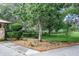 Well-maintained landscaping frames the yard, enhancing the home's curb appeal with lush greenery and charming flowerbeds at 1273 Scrub Jay Trl, Frostproof, FL 33843