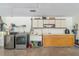 Spacious laundry room featuring modern washer/dryer, ample counter space, and cabinet storage at 1273 Scrub Jay Trl, Frostproof, FL 33843