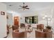 Inviting living room features tile floors, natural light, and comfortable leather chairs, ideal for relaxation and conversation at 1273 Scrub Jay Trl, Frostproof, FL 33843