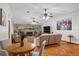 Cozy living room featuring a stone fireplace, hardwood floors, and comfortable seating at 1273 Scrub Jay Trl, Frostproof, FL 33843