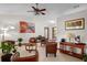Bright living room featuring neutral tile flooring, comfortable seating, and tasteful decor at 1273 Scrub Jay Trl, Frostproof, FL 33843