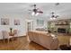 Comfortable living room with stone fireplace and backyard view, seamlessly connected to the dining area, ideal for Gathering living at 1273 Scrub Jay Trl, Frostproof, FL 33843