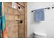 This bathroom features a tile shower with glass block window and bronze fixtures at 1273 Scrub Jay Trl, Frostproof, FL 33843