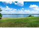 Expansive backyard with lush green grass and picturesque lake view at 1334 Highland Park S Dr, Lake Wales, FL 33898