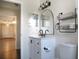 Updated bathroom with modern fixtures, decorative mirror, open storage, and stylish vanity with drawers at 1334 Highland Park S Dr, Lake Wales, FL 33898