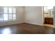 Bright bedroom with wood-look floors with natural light and adjacent bathroom access at 1334 Highland Park S Dr, Lake Wales, FL 33898