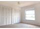 This bedroom has carpet flooring, two closets, a ceiling fan and a window at 1334 Highland Park S Dr, Lake Wales, FL 33898