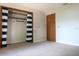Spacious bedroom features a closet with striped curtains and a door at 1334 Highland Park S Dr, Lake Wales, FL 33898