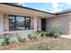 Inviting front entrance with decorative shutters, stone accents, and lush landscaping at 1334 Highland Park S Dr, Lake Wales, FL 33898