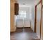 Bright laundry room features a modern washer and dryer set next to a window and wood-look floors at 1334 Highland Park S Dr, Lake Wales, FL 33898