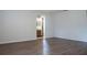 Spacious living room with wood-look floors that leads to the bathroom, perfect for comfortable living at 1334 Highland Park S Dr, Lake Wales, FL 33898