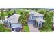 Sprawling two-story home with adjacent golf course; lush landscaping surrounds paved driveway at 1433 Bunker Dr, Davenport, FL 33896