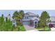 Two-story home shows gray color scheme, adjacent matching homes, and well maintained landscaping at 1433 Bunker Dr, Davenport, FL 33896