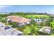 Aerial view showcasing the community clubhouse, pool, and surrounding green spaces in a vibrant setting at 1433 Bunker Dr, Davenport, FL 33896
