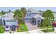 Aerial shot showcases a two-story home, lush landscaping, and a paved driveway at 1433 Bunker Dr, Davenport, FL 33896