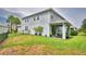 A spacious backyard with a covered patio and a lush green lawn, perfect for outdoor enjoyment at 1433 Bunker Dr, Davenport, FL 33896