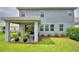 Exterior view of a home with a covered patio area surrounded by well-maintained landscaping at 1433 Bunker Dr, Davenport, FL 33896