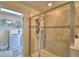 Bathroom featuring tiled shower with glass door and laundry room in the background at 1433 Bunker Dr, Davenport, FL 33896