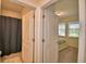 Bathroom doorway between bedroom and bathroom with shower behind a curtain at 1433 Bunker Dr, Davenport, FL 33896