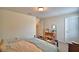 Bedroom with a desk, neutral walls, carpeted floor and a comfortable bed with a throw at 1433 Bunker Dr, Davenport, FL 33896