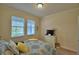 Bedroom featuring two windows, patterned bedding, carpet, and a dresser with a TV at 1433 Bunker Dr, Davenport, FL 33896